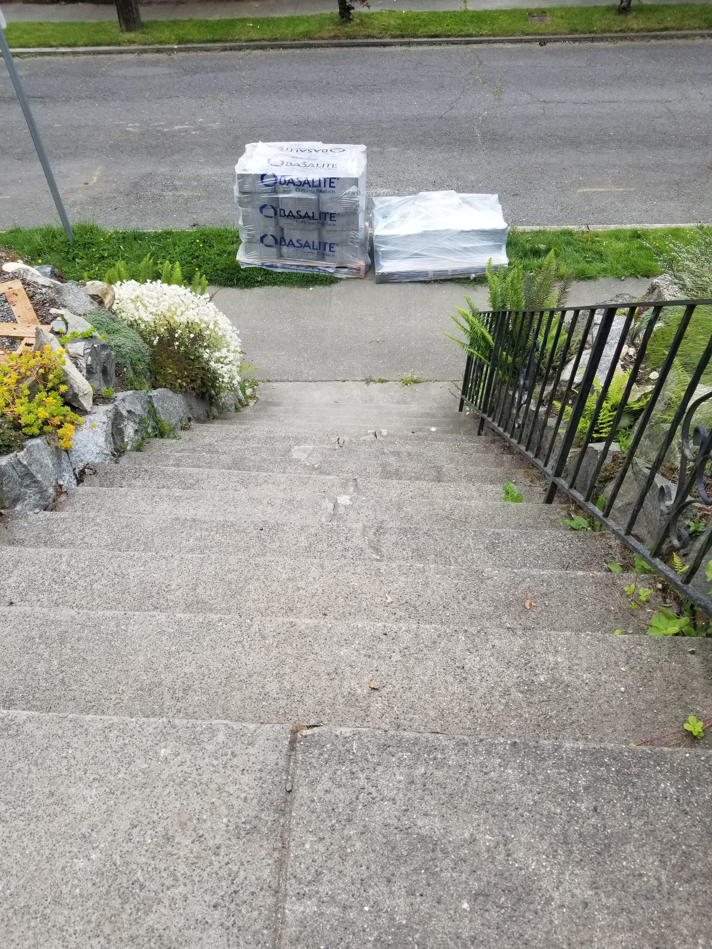 Front steps with blocks for wall and patio pavers at bottom.