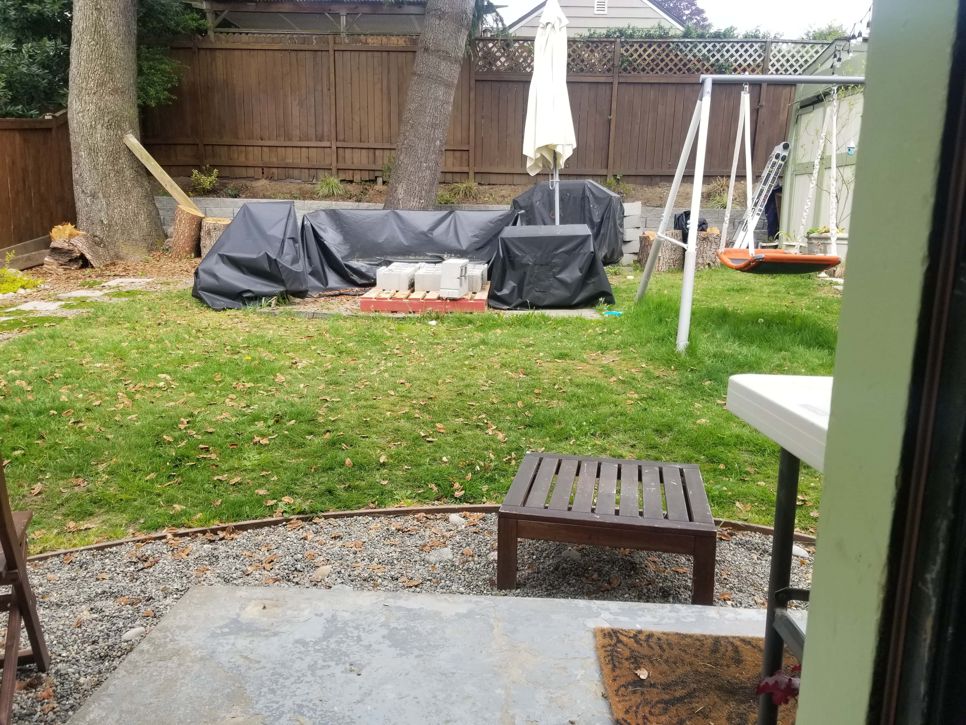 Backyard before with materials for project.